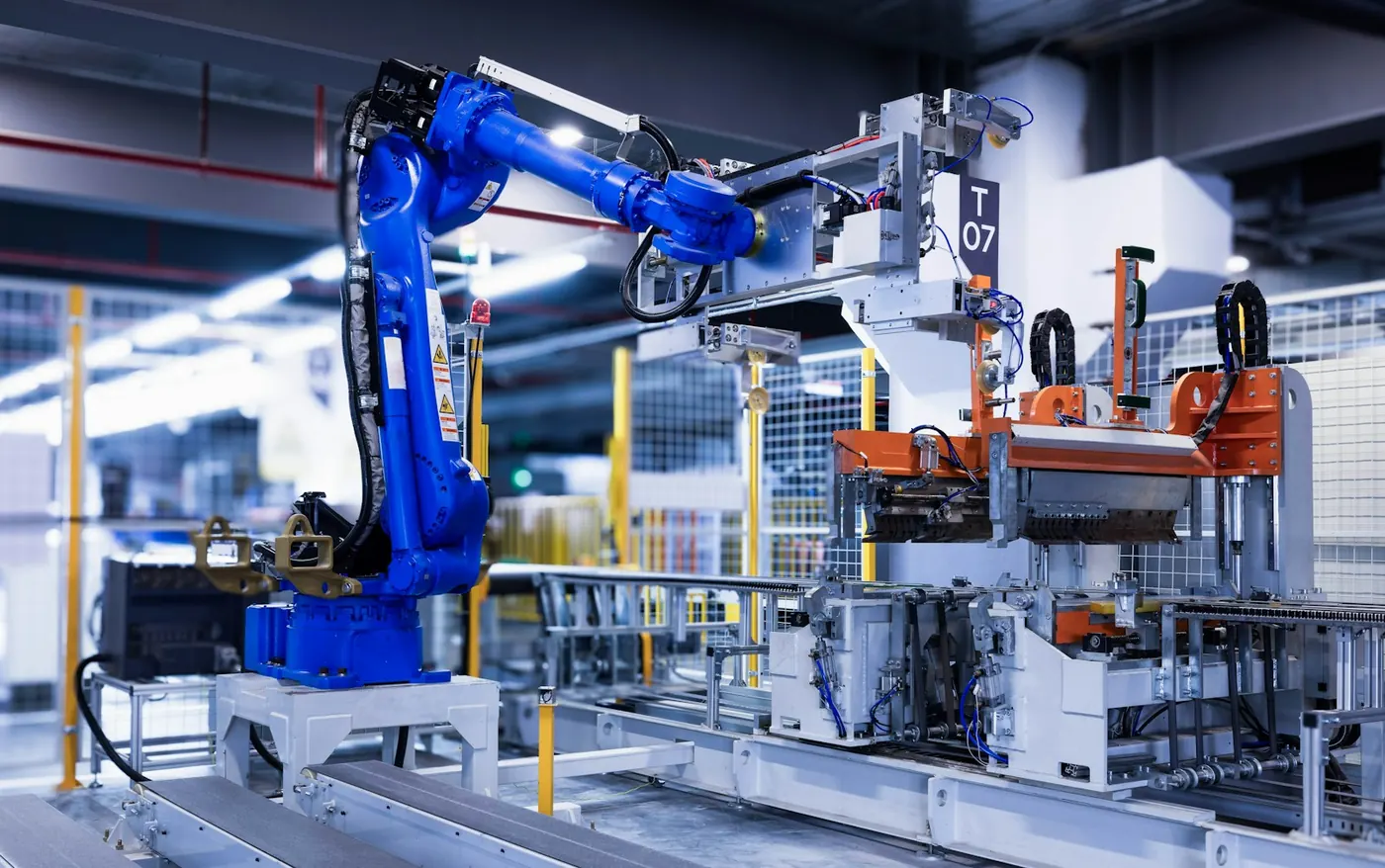 An industrial robot arm working inside an automated production cell