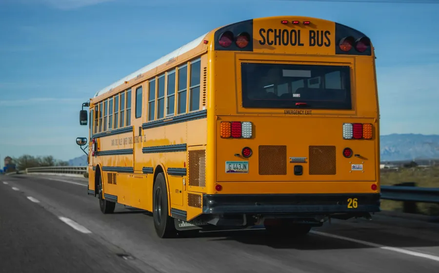 A yellow school bus on its morning route